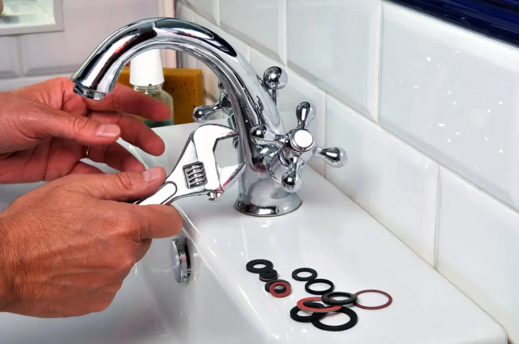 Plumber performing maintenance on a bathroom faucet in Lakeland