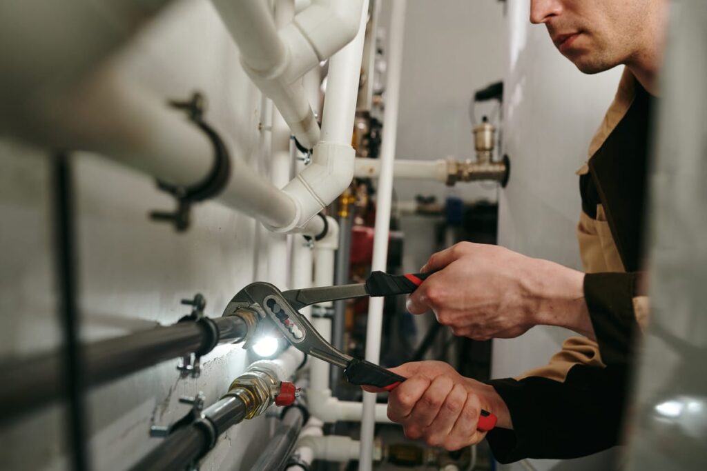 Plumbers maintaining commercial plumbing pipes in Lakeland