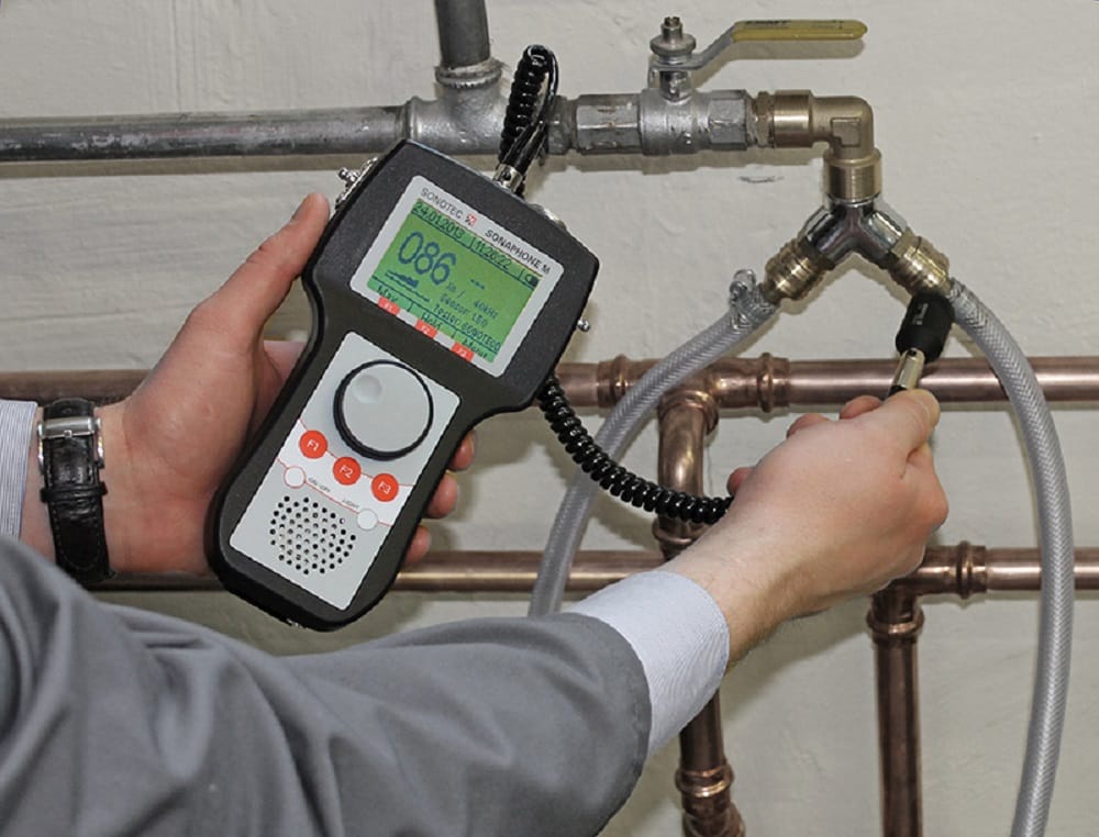 Plumber testing pipes with electronic leak detection equipment in Lakeland