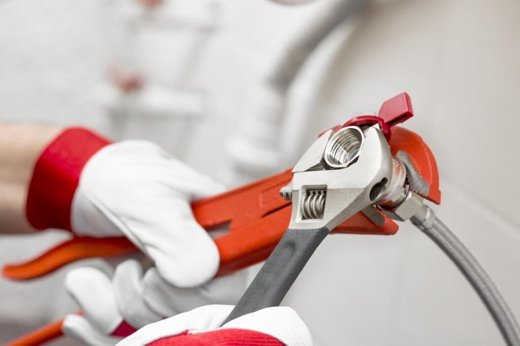 Plumber holding pipe wrenches for an emergency repair in Lakeland