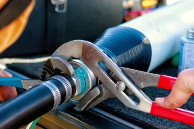 Technician tightening an industrial pipe connection in Lakeland