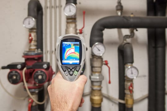 Plumber using a thermal imaging camera to inspect pipes in Lakeland