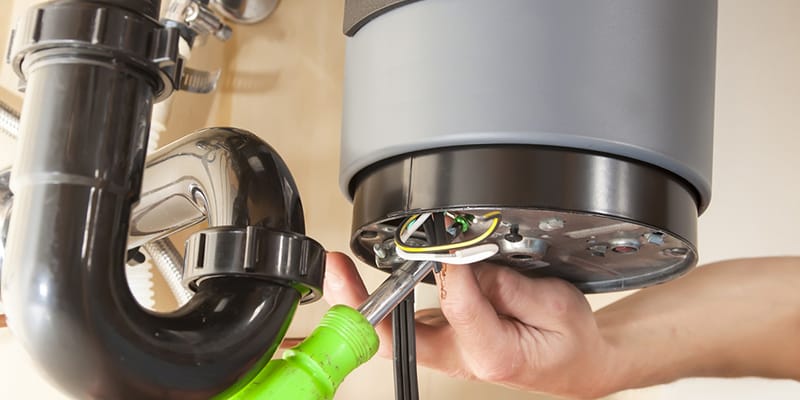 Technician repairing the heating element of a water heater in Lakeland