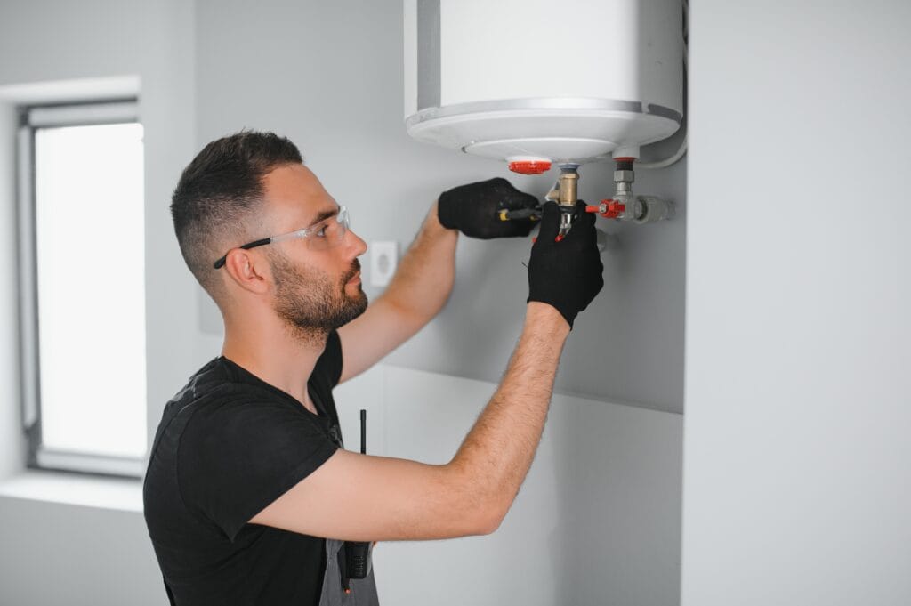Technician performing water heater maintenance in Lakeland