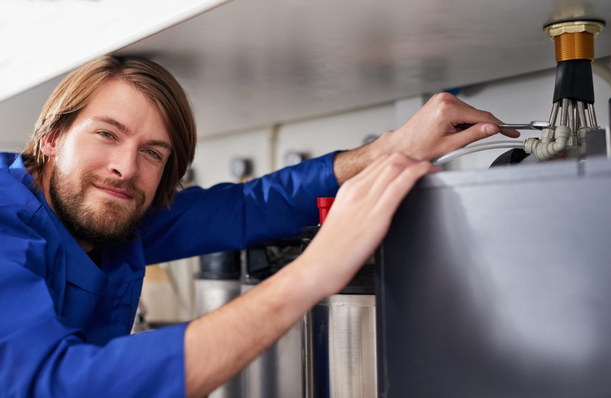 Technician servicing a residential water heater tank in Lakeland