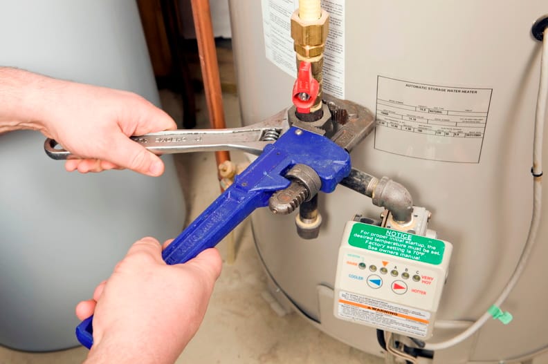 Plumber repairing a water heater valve in Lakeland